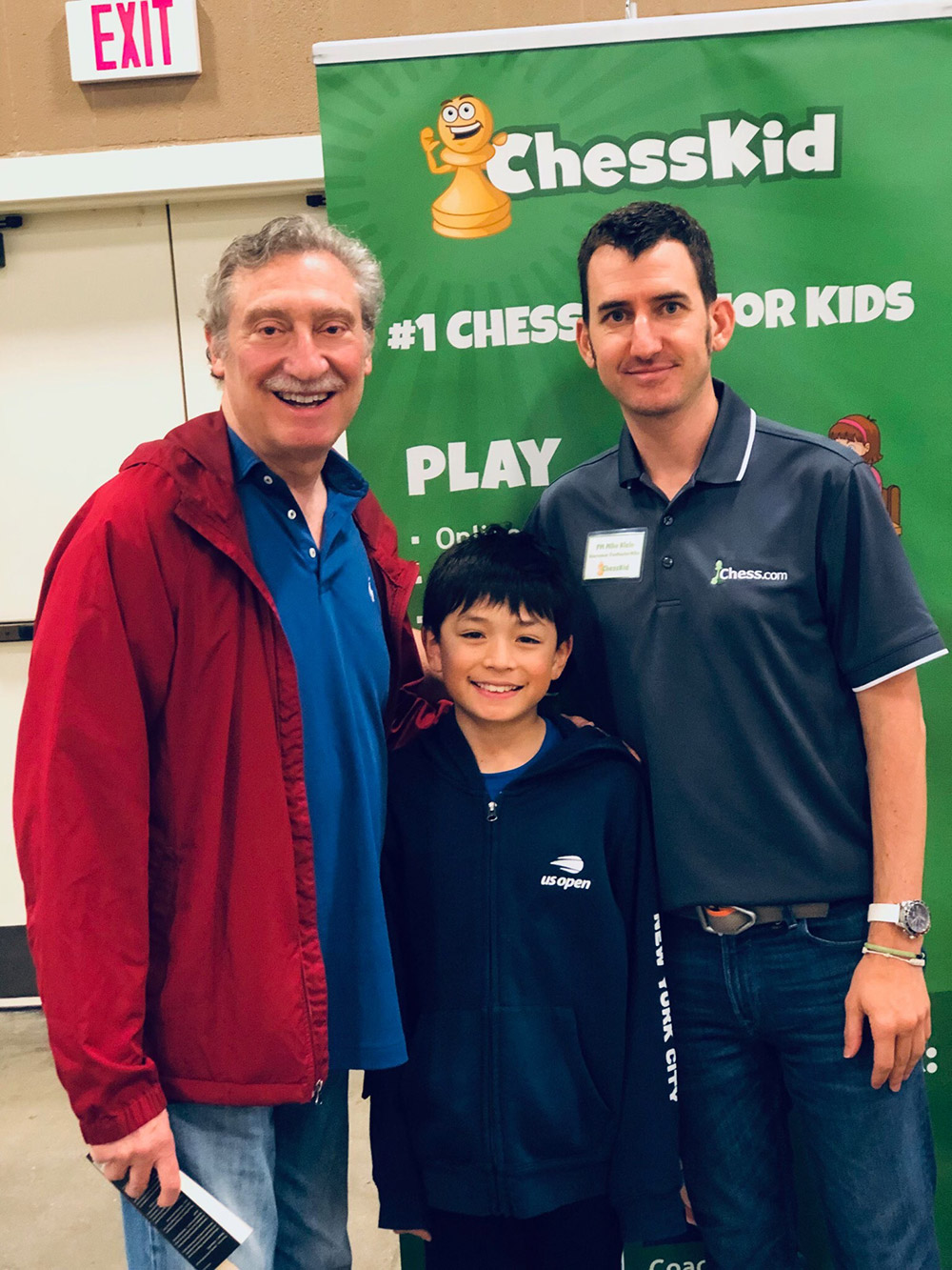 Oliver takes a break between chess rounds, with NM Bruce Pandolfini (left) and FM Mike Klein (right) at the 2019 National Elementary (K-6) Championships, held at the Gaylord Opryland Resort and Convention Center in Nashville. May, 2019