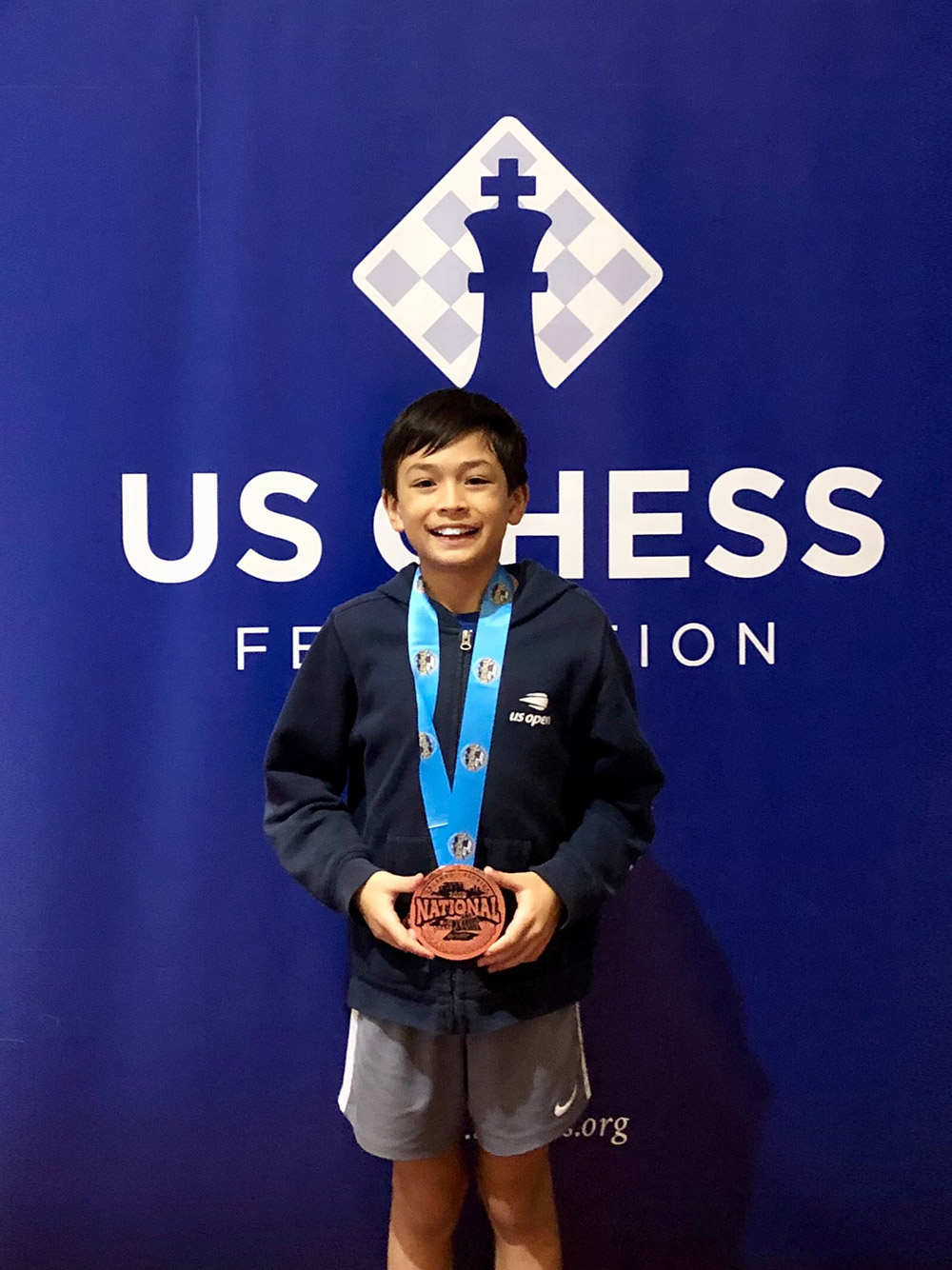 Oliver receives a medal at the 2019 National K-12 Grade Chess Championships in Orlando. December, 2019