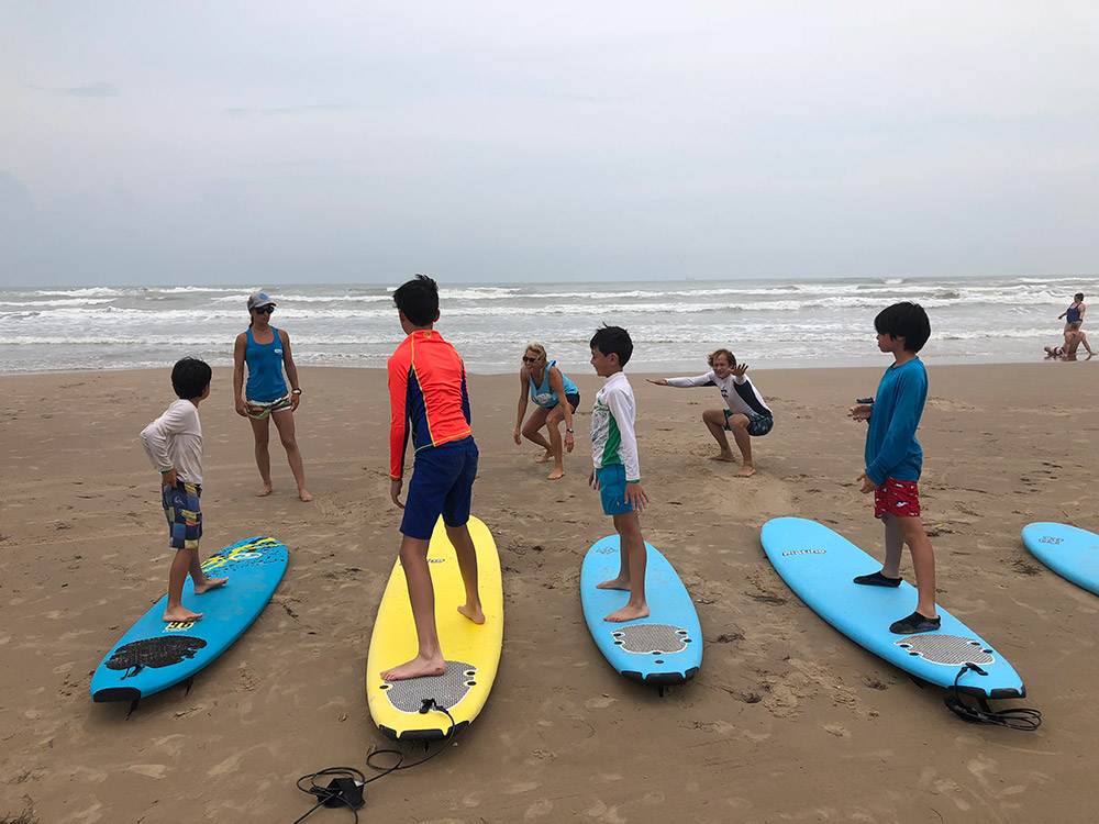 Surf's up! Oliver (3rd from left) takes a surf lesson on South Padre Island in Texas with his older brother, Sebastien, and his cousins, Reagan and Robbie. June, 2018